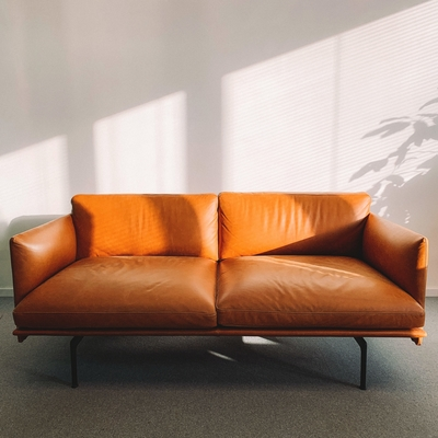 Brown leather sofa in light coloured room