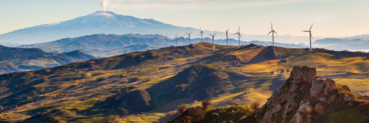 Photo of hills with wind turbines