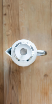 Birds-eye-view photo of a kettle on wooden worktop