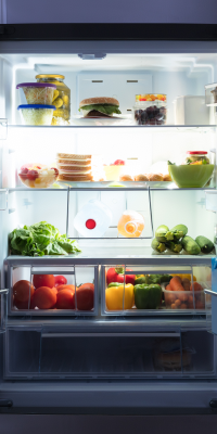 A photo of a fridge with the doors open, full of food