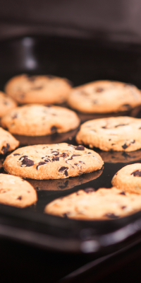 A tray of cookies being taken out of the oven