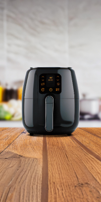 Photo of a black air fryer in on a kitchen worktop