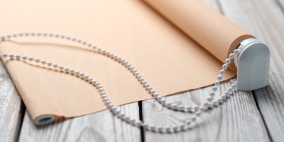 Photo of a the mechanism on a beige roller blind