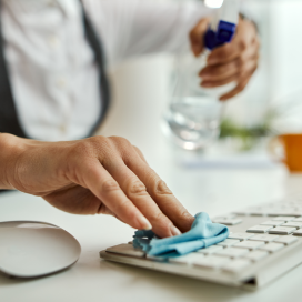 Photo of a person cleaning a keyboard