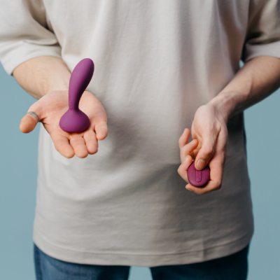 Photo of a person holding a purple sex toy
