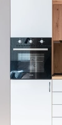 Close-up of an integrated oven in a modern white high gloss kitchen