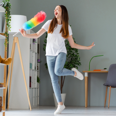 Young lady cleaning and singing