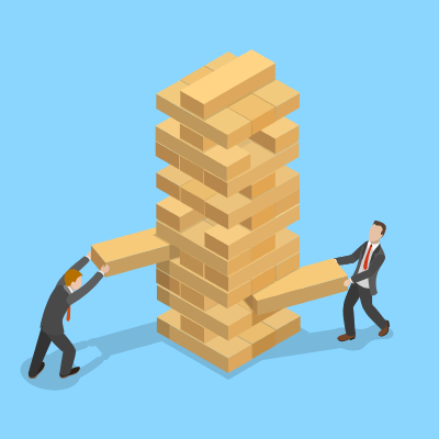 Men taking risks playing Jenga