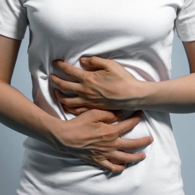 Woman holding upset tummy due to norovirus