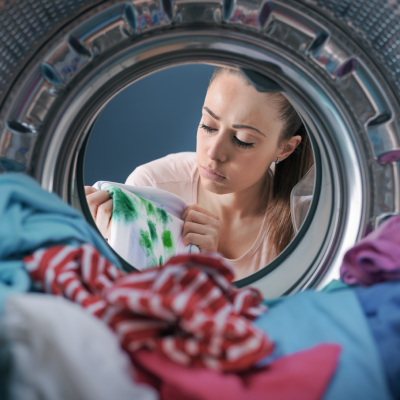 Woman washing stained clothing