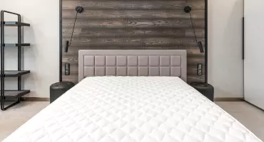 Photo of a mattress on a bed, ready for cleaning