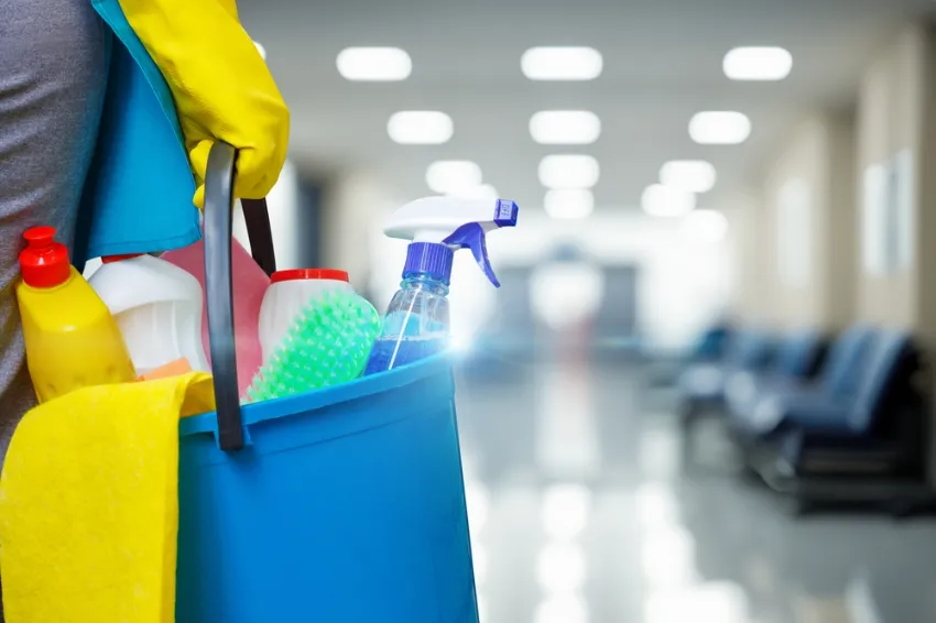 Woman holding cleaning supplies