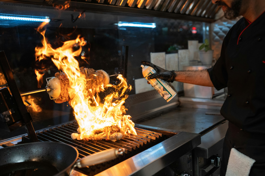 Flame grilling a kebab in a commercial kitchen