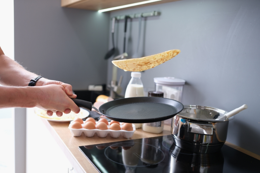 Man flipping pancakes
