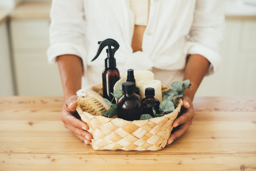 Lady with a basket of eco friendly cleaning products