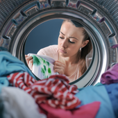Woman washing stained clothing