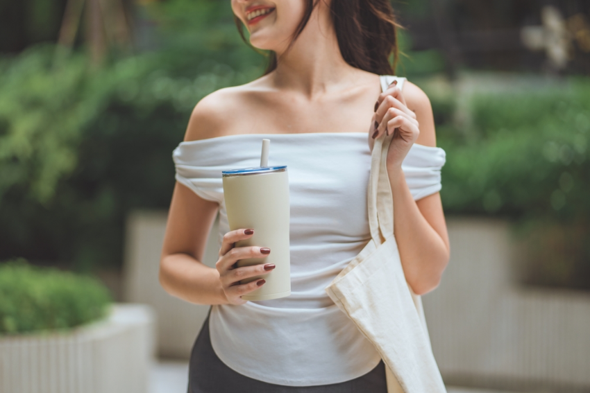 Lady holding reusable cup