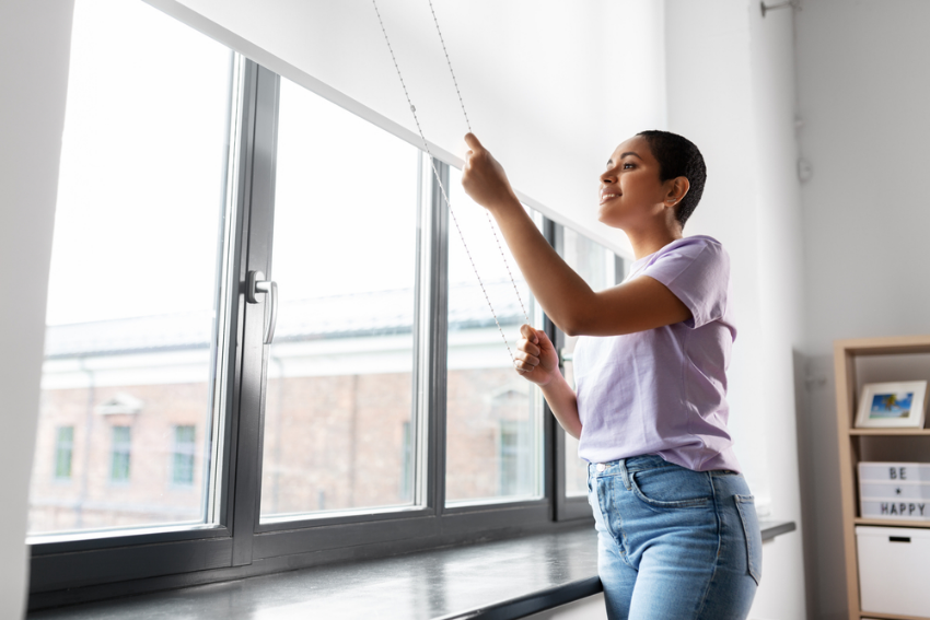 Lady using a roller blind
