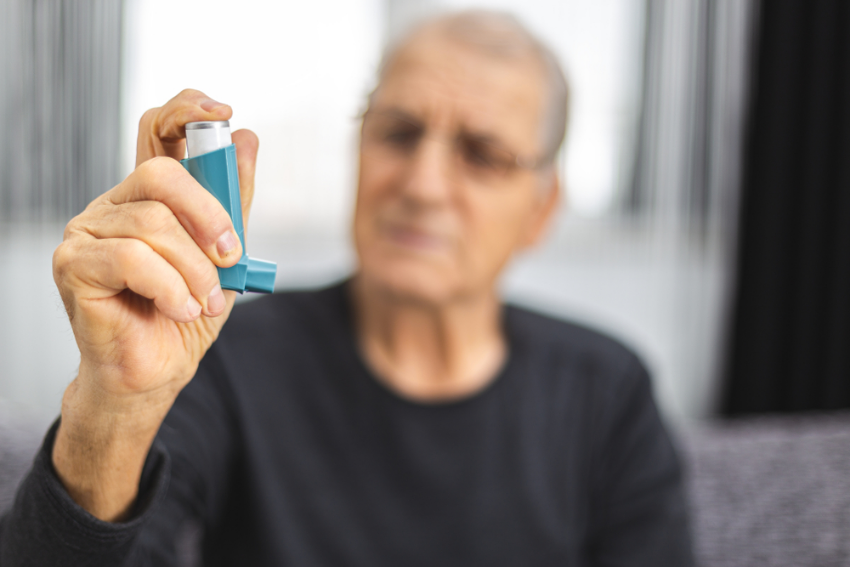 Man holding an asthma inhaler