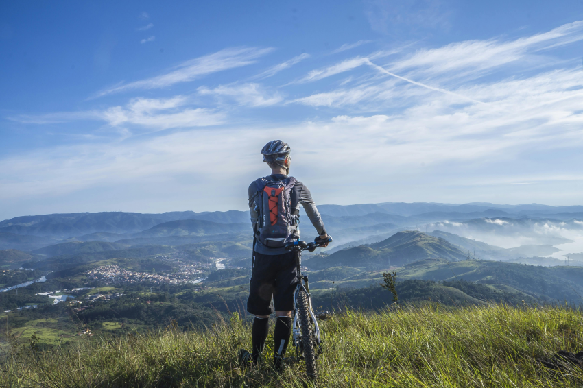 Person with their mountain bike at the top of a hill
