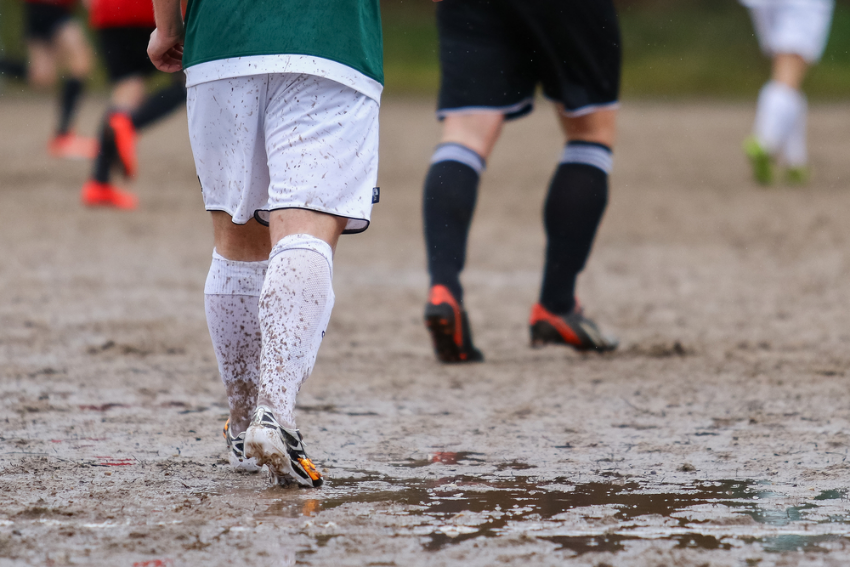 Playing football in a muddy field