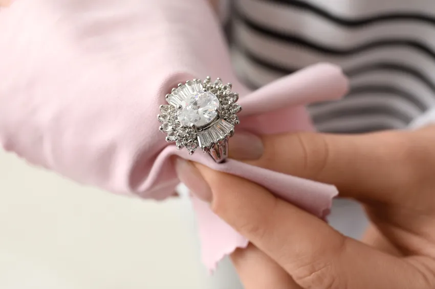 Polishing a silver ring with a cloth