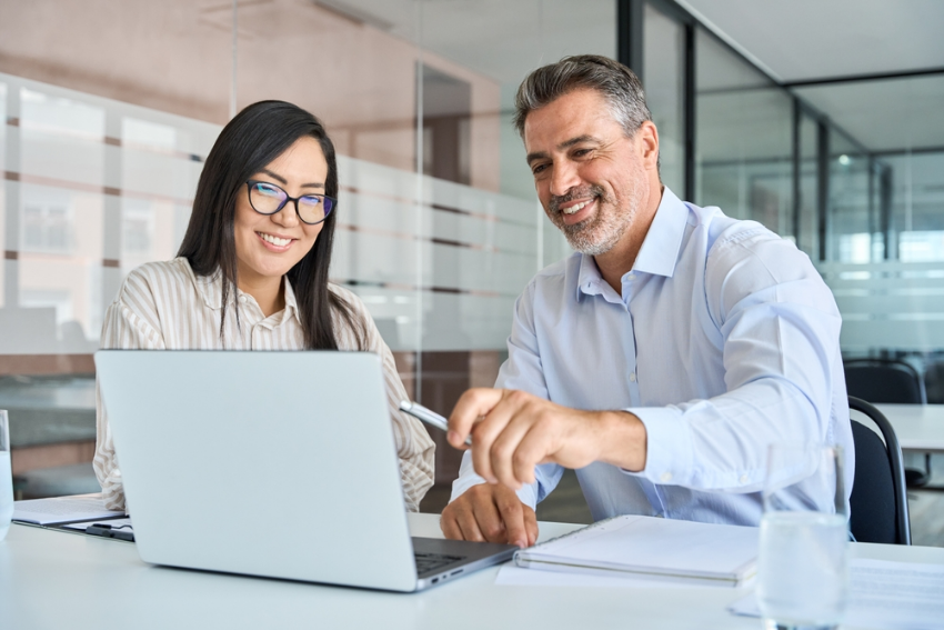 Two people training on a laptop