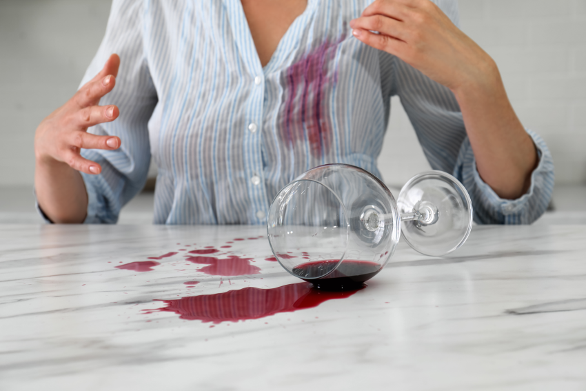 Woman spilling red wine