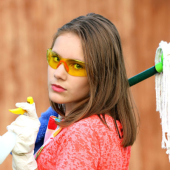 Lady holding mop looking at the camera