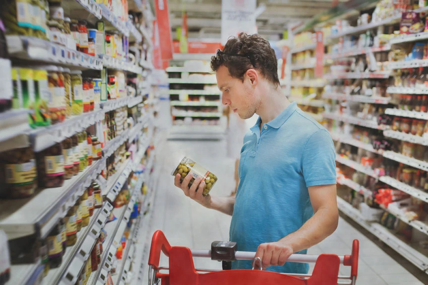 Checking product label in supermarket