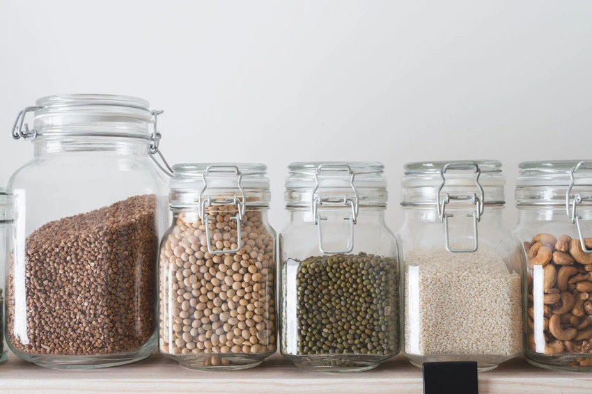 Dried goods in jars on kitchen shelf