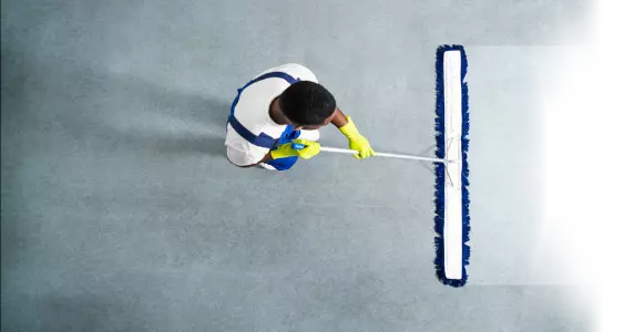 Man sweeping floor from above